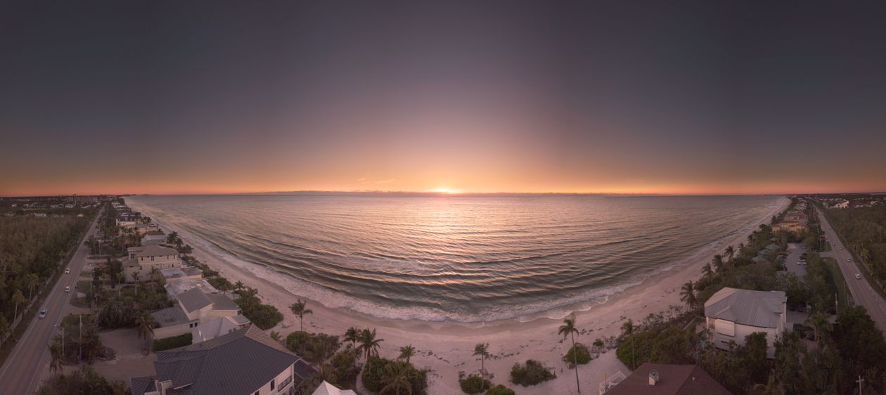 Panoramic Gulf Coast sunset over beachfront homes
